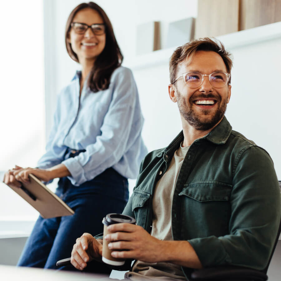 Two coworkers smiling in a meeting